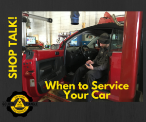 ASE Mechanic sitting in red VW Bug completing service check up