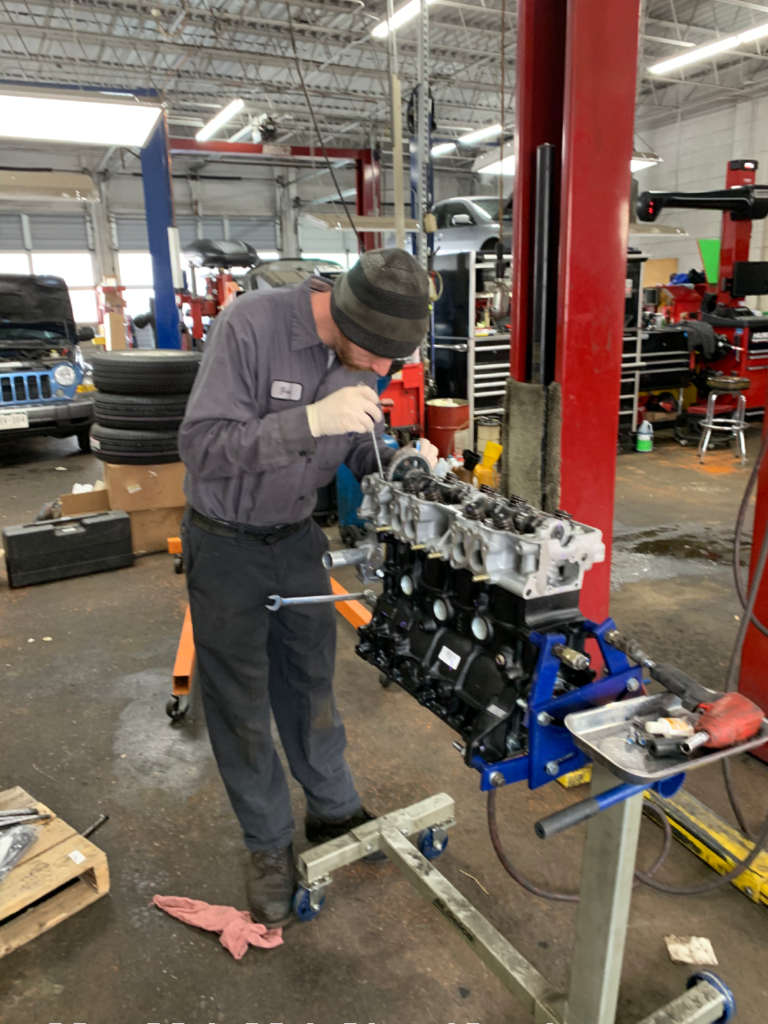 ASE Tech Zach inspects the engine before rebuild