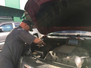 Dave working under the hood of a vehicle at Golden Triangle Auto Care